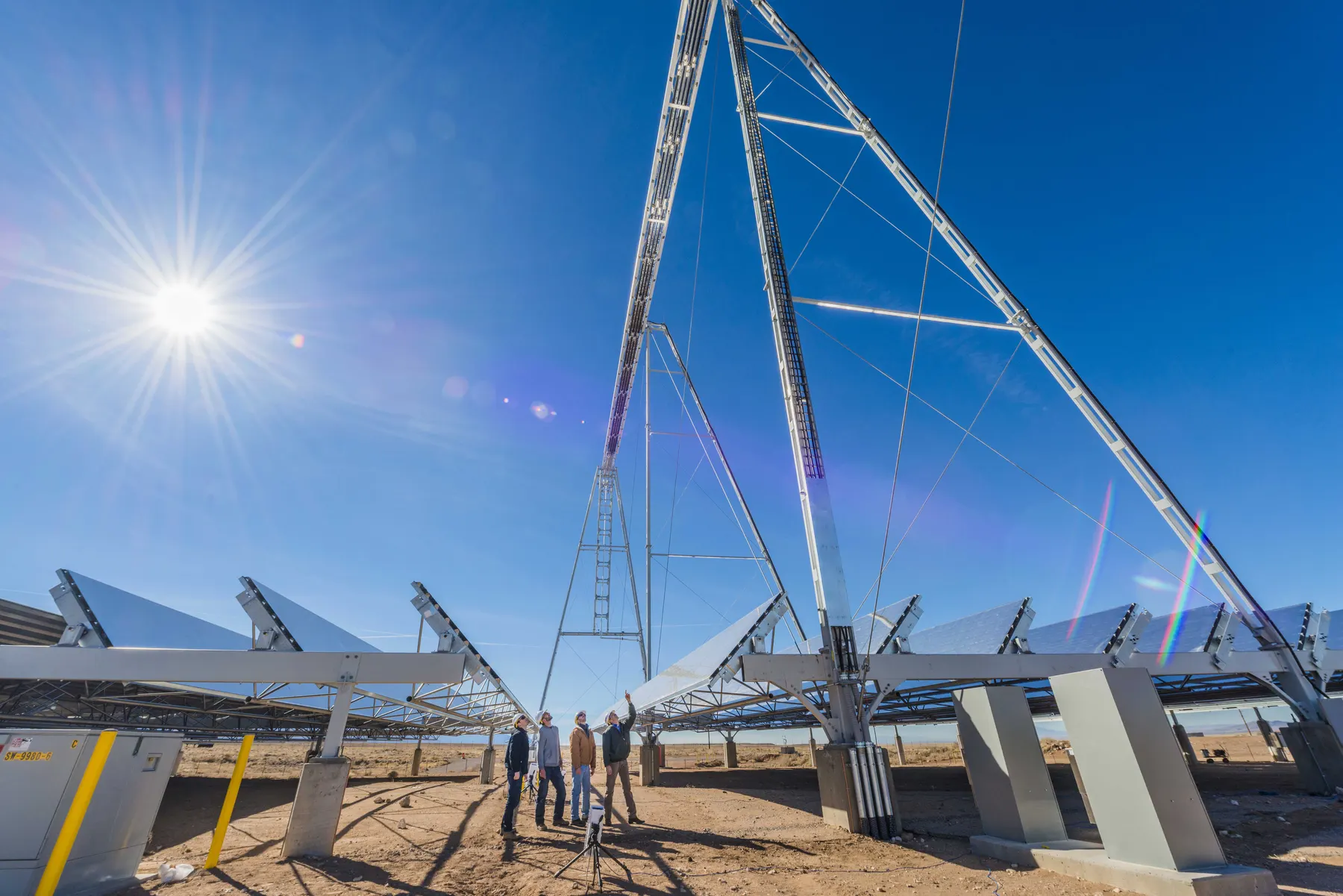 Engineers and test equipment in a desert concentrated solar power test field.